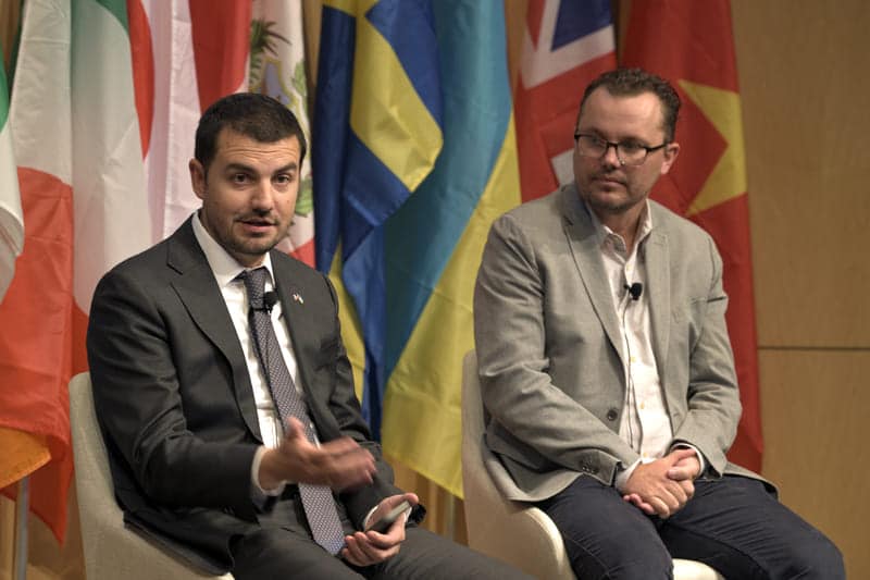 two guys sitting on a stage