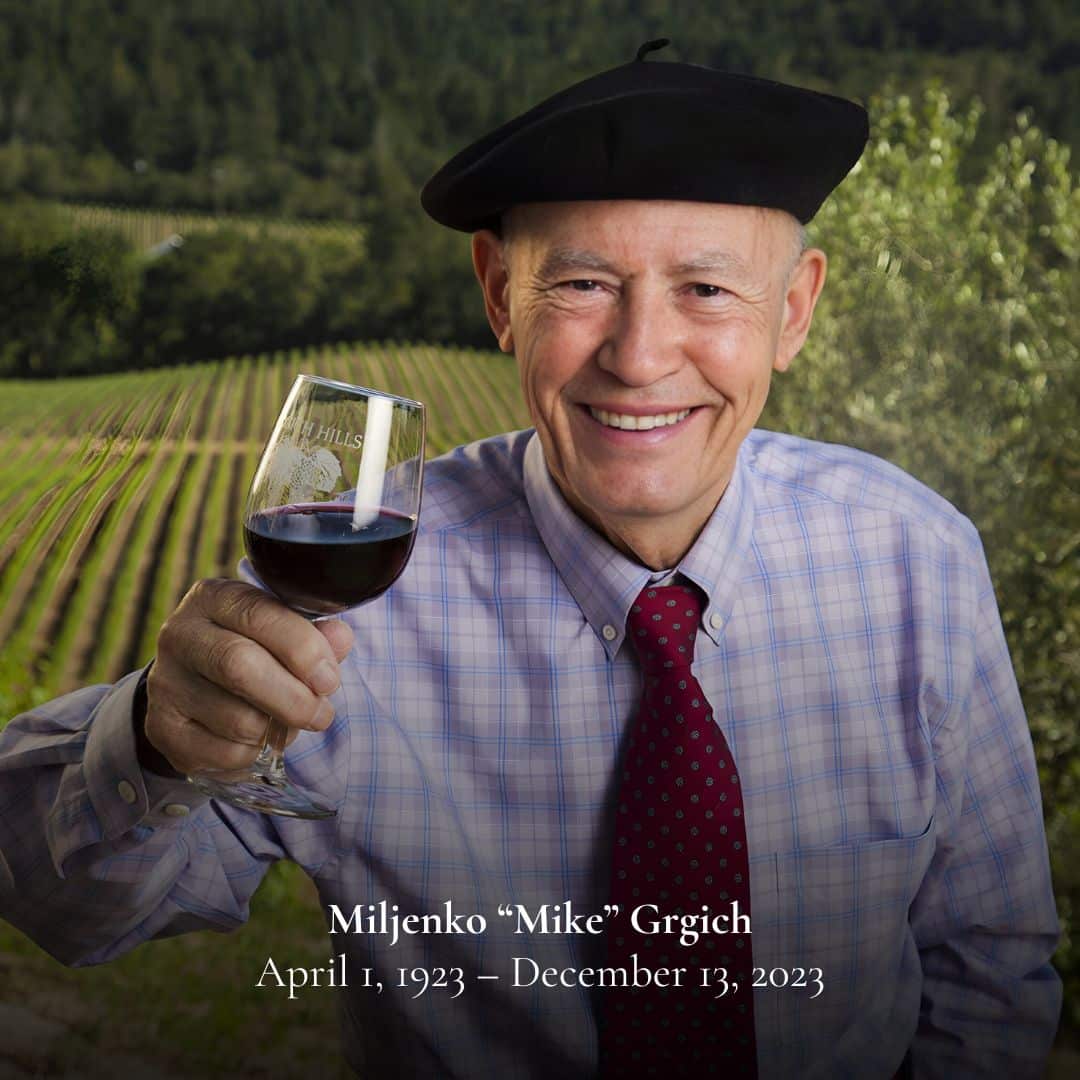 mike grgich holding wine glass