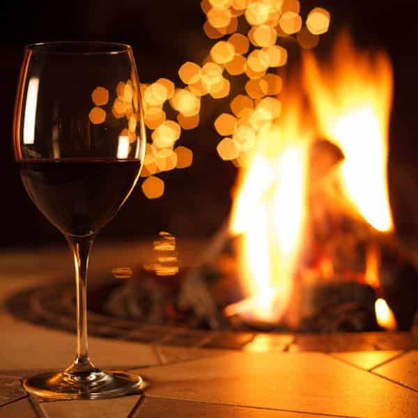 glass of wine next to fire